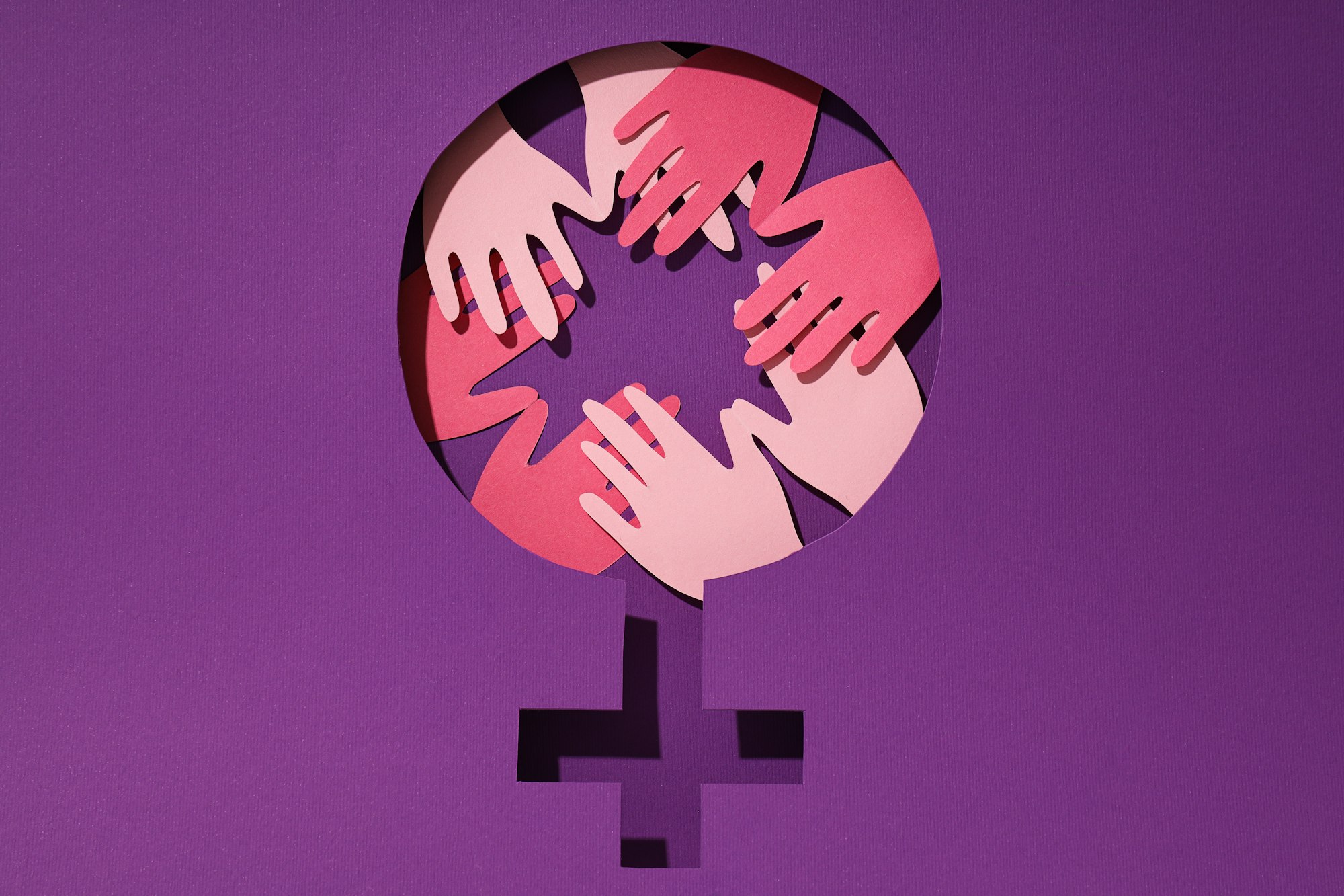 Female symbol on purple background, elimination of domestic violence.